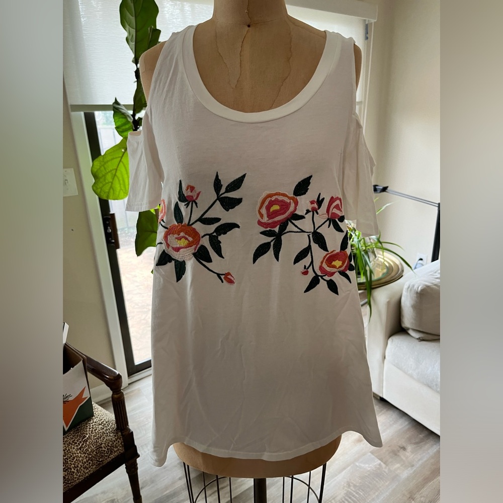 White tee, bare shoulders, embroidered flowers on front.  Sugar Lips size L